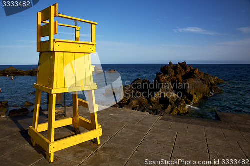 Image of yellow lifeguard chair cabin  in spain  lanzarote  rock stone sk