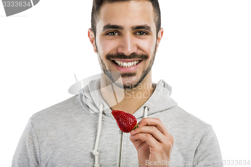 Image of Happy young eating a strawberry