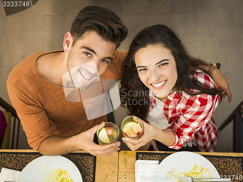 Image of Young couple toasting