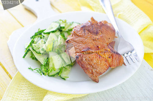 Image of meat with salad
