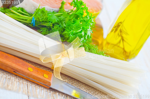 Image of raw rice noodles and raw salmon