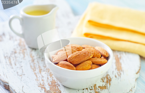 Image of almond essential oil and almond in bowl