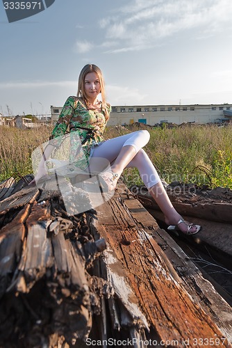 Image of Pretty girl on industrial background