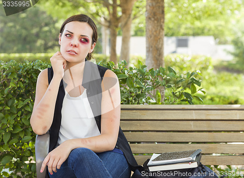 Image of Depressed Bruised and Battered Young Woman on Bench