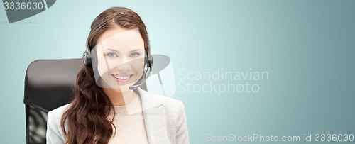 Image of smiling female helpline operator with headset