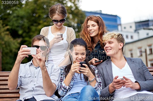 Image of students or teenagers with smartphones at campus