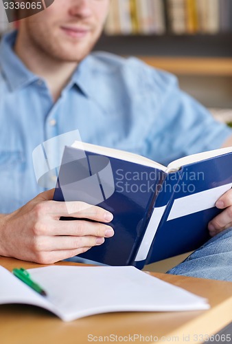 Image of close up of student reading book at school