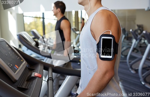 Image of close up of man with smartphone in gym
