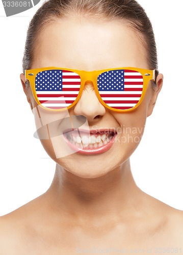 Image of happy teenage girl in shades with american flag