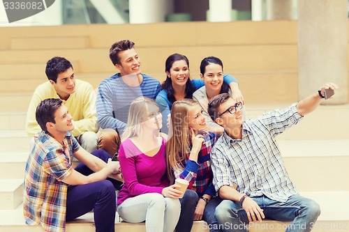 Image of group of students with smartphone and coffee cup