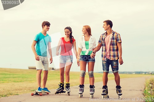 Image of group of smiling teenagers with roller-skates