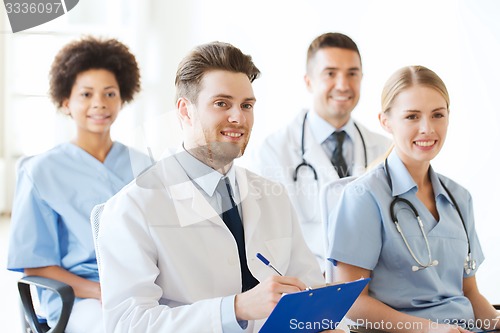 Image of group of happy doctors on seminar at hospital