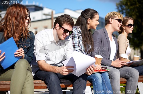 Image of group of happy students with notebooks and coffee