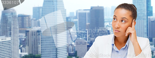 Image of african businesswoman looking up and thinking