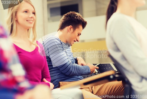 Image of group of smiling students in lecture hall