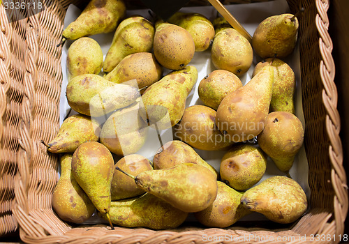 Image of ripe pears in basket at food market or farm