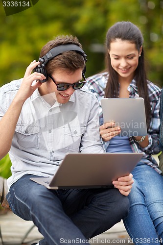 Image of students or teenagers with laptop computers