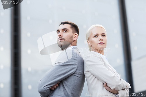 Image of businessman and businesswoman outdoors