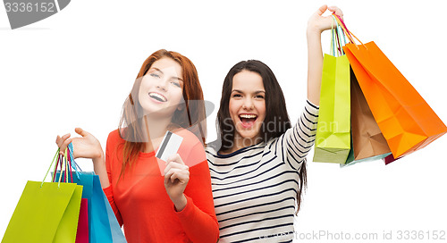 Image of teenage girls with shopping bags and credit card