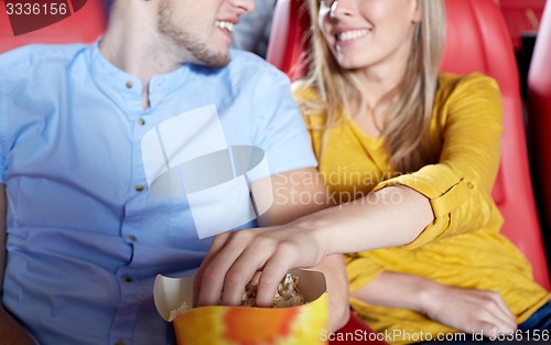 Image of happy couple watching movie in theater or cinema