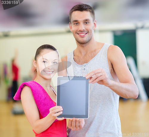 Image of two smiling people showing blank tablet pc screen