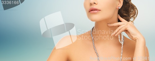 Image of woman with pearl earrings and necklace