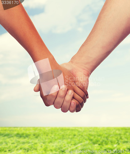 Image of woman and man holding hands