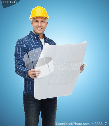 Image of smiling male builder in helmet with blueprint