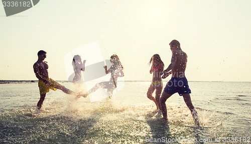 Image of happy friends having fun on summer beach