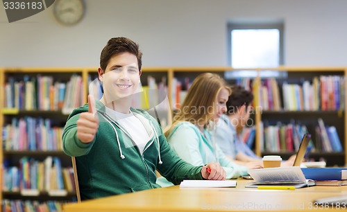 Image of happy student boy preparing to exam in library