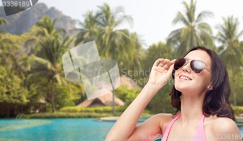 Image of happy woman in sunglasses and swimsuit