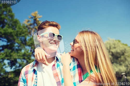 Image of smiling couple having fun outdoors