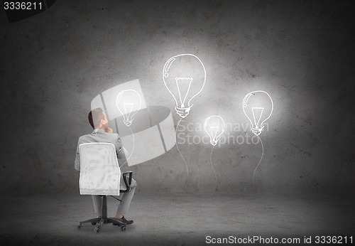 Image of businessman in office chair over white board