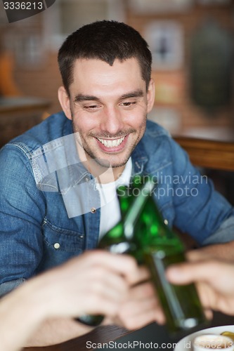 Image of happy male friends drinking beer at bar or pub