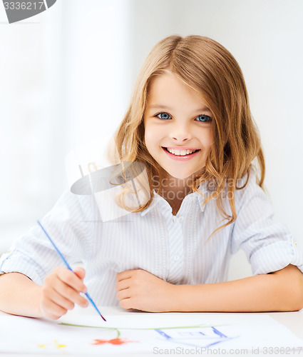Image of little girl painting at school