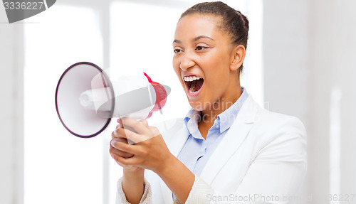 Image of strict businesswoman shouting in megaphone