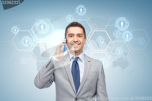 Image of happy businessman calling on smartphone