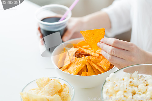 Image of close up of woman with junk food and coca cola cup