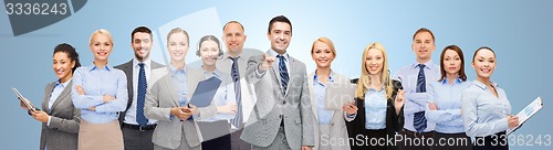 Image of group of happy business people pointing at you