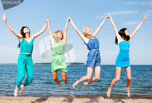 Image of girls jumping on the beach