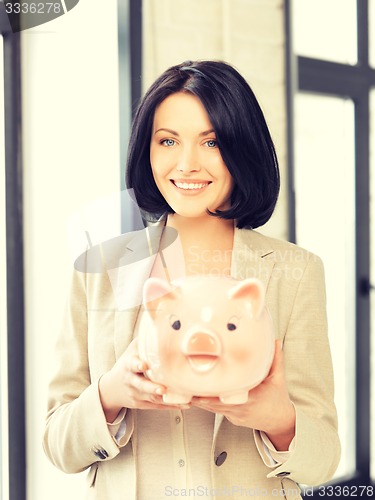 Image of lovely woman with piggy bank