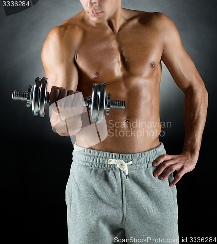 Image of young man with dumbbell