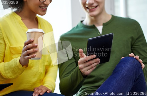Image of close up of students with tablet pc and coffee