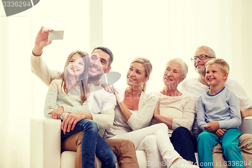 Image of happy family with smartphone at home