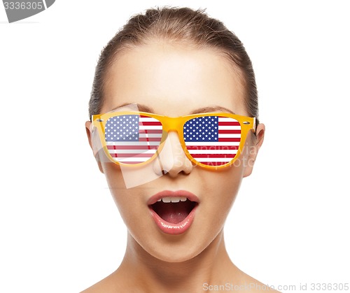 Image of happy teenage girl in shades with american flag