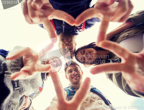 Image of group of smiling friends with backpacks hiking