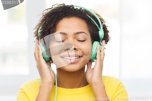 Image of happy woman with headphones listening to music