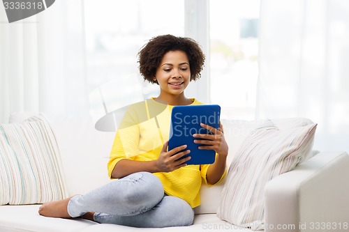 Image of happy african american woman with tablet pc