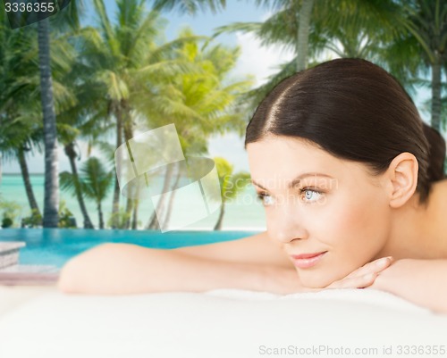 Image of happy beautiful woman lying in spa