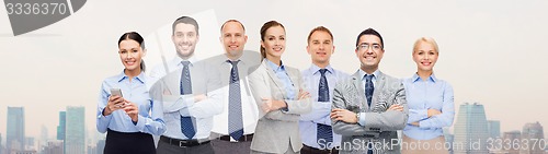 Image of group of happy businesspeople with crossed arms